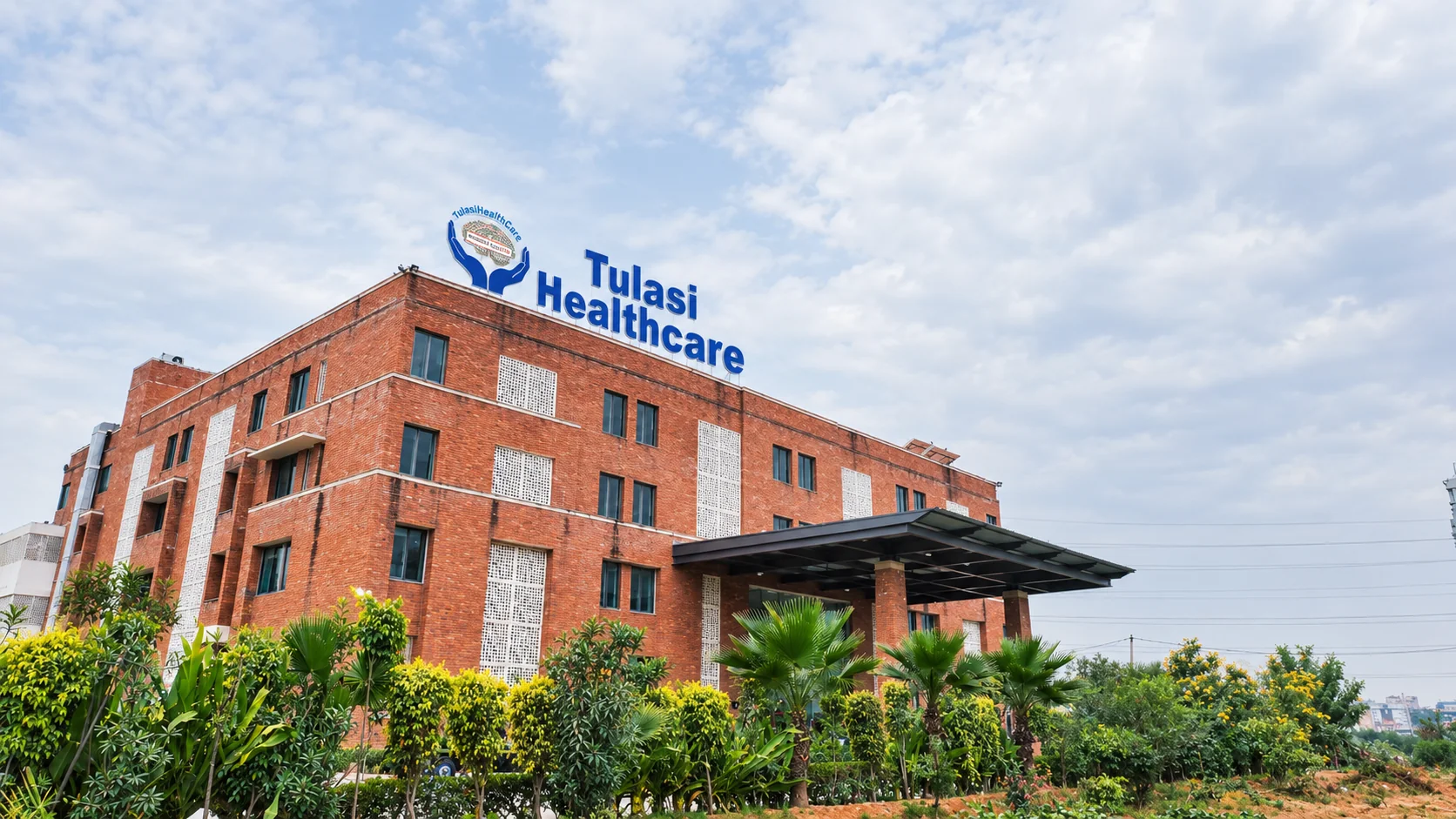 The brick entrance of Tulasi Healthcare Hospital in Gurugram