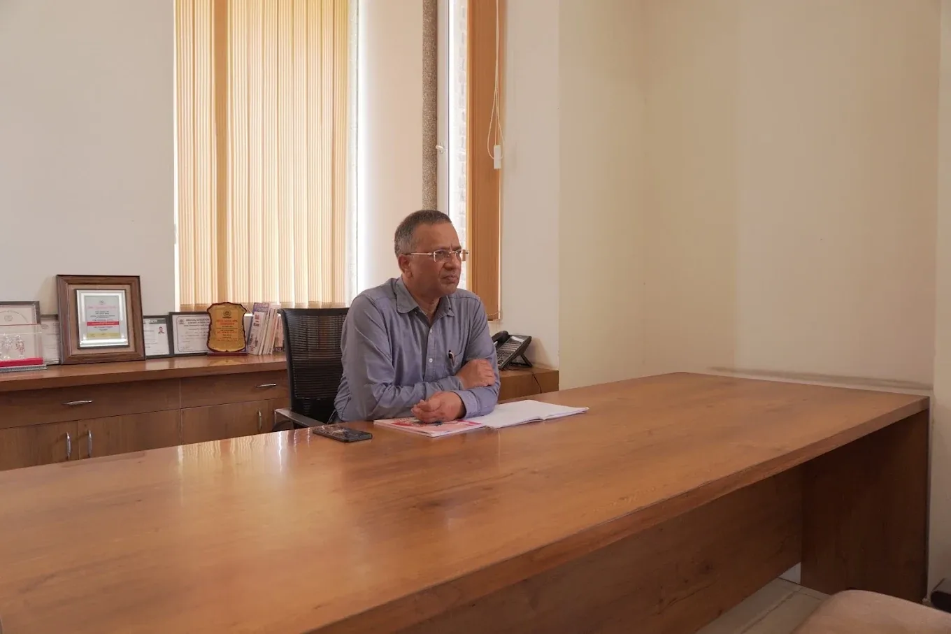 Dr. Gorav Gupta at his desk in the New Delhi consulting room
