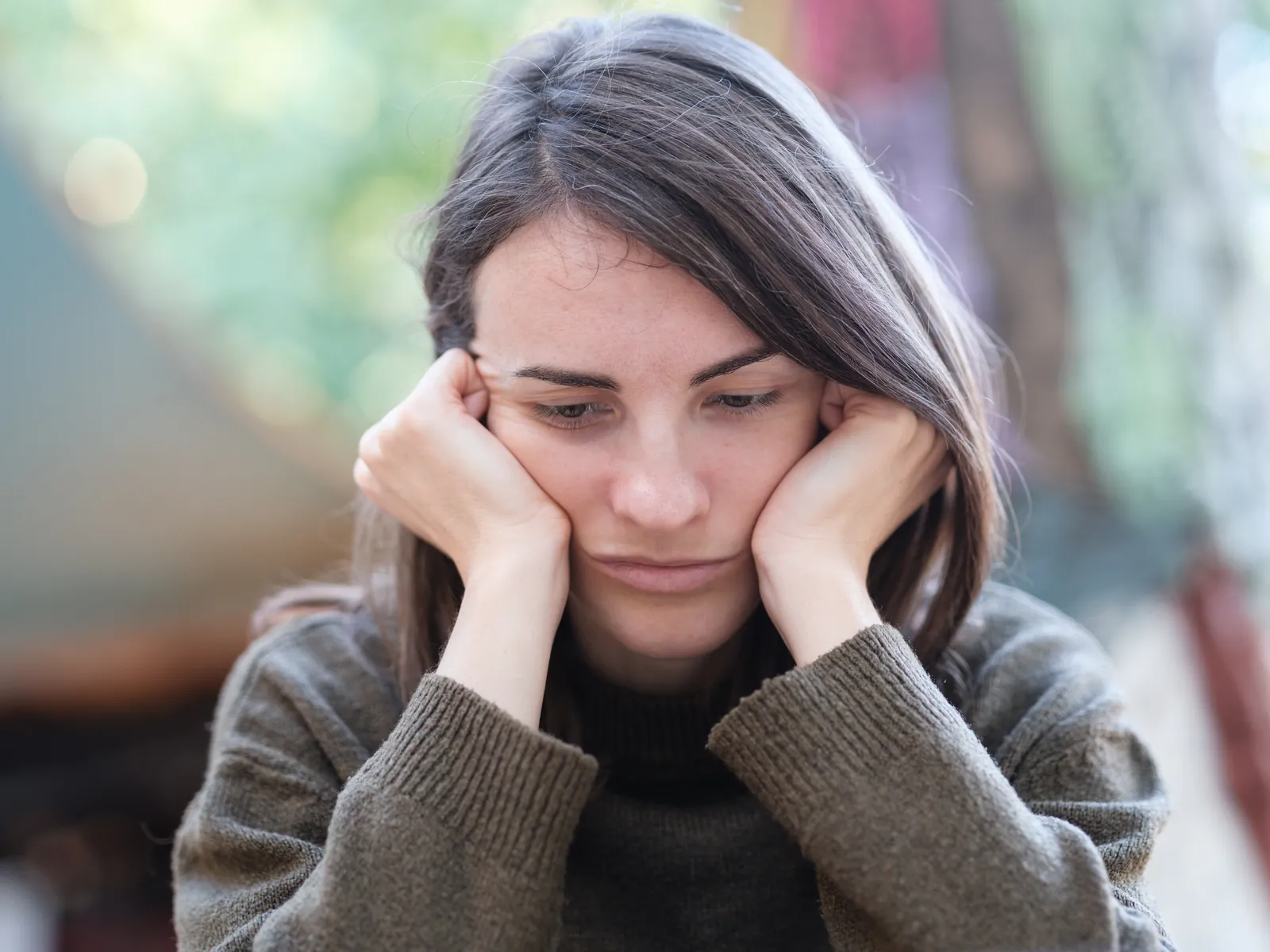 A woman holding her head in her hands